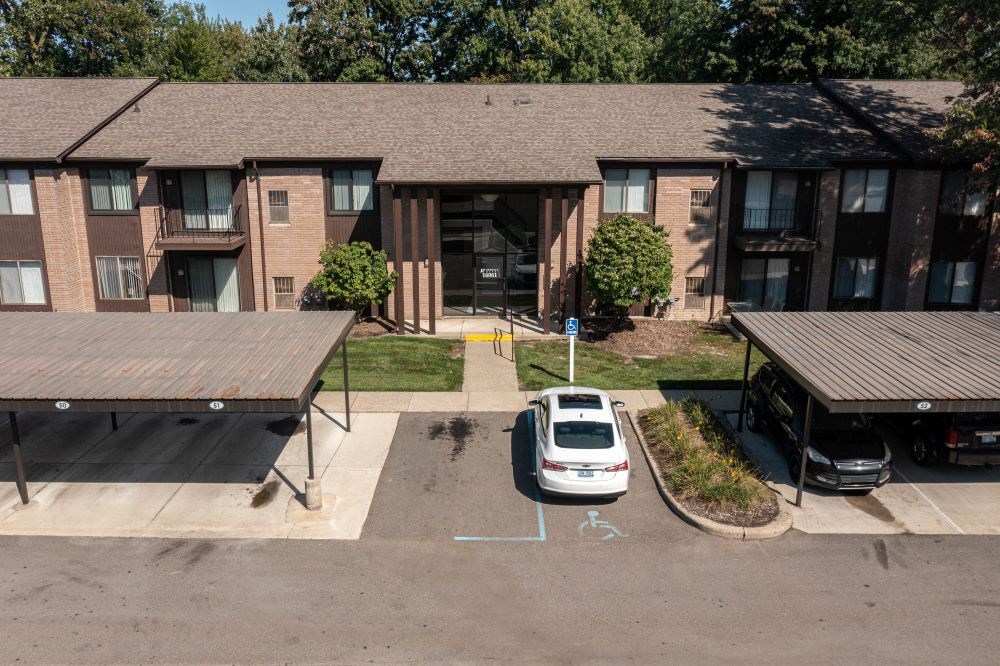 a car parked in front of an apartment building
